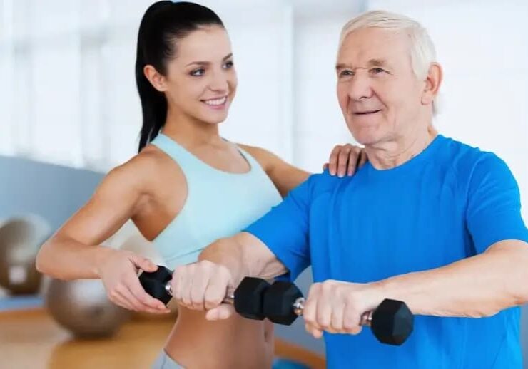 Home health care professional assisting an older adult with strength and mobility exercises, representing transition and recovery support through in-home senior care services from OneCare Harmony.